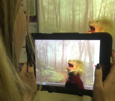 Woman filming with a tablet