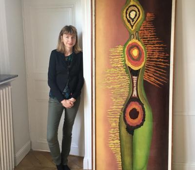 Sacha Llewellyn standing by a painting